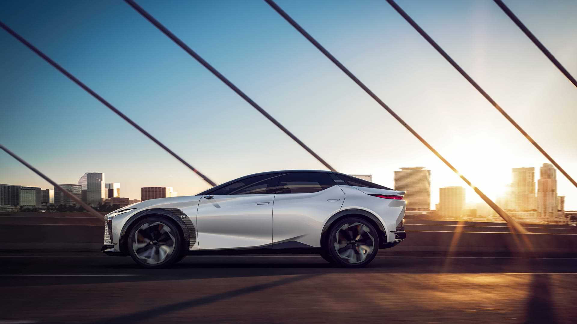 Concept vehicle LF-Z drives across a bridge during sunset