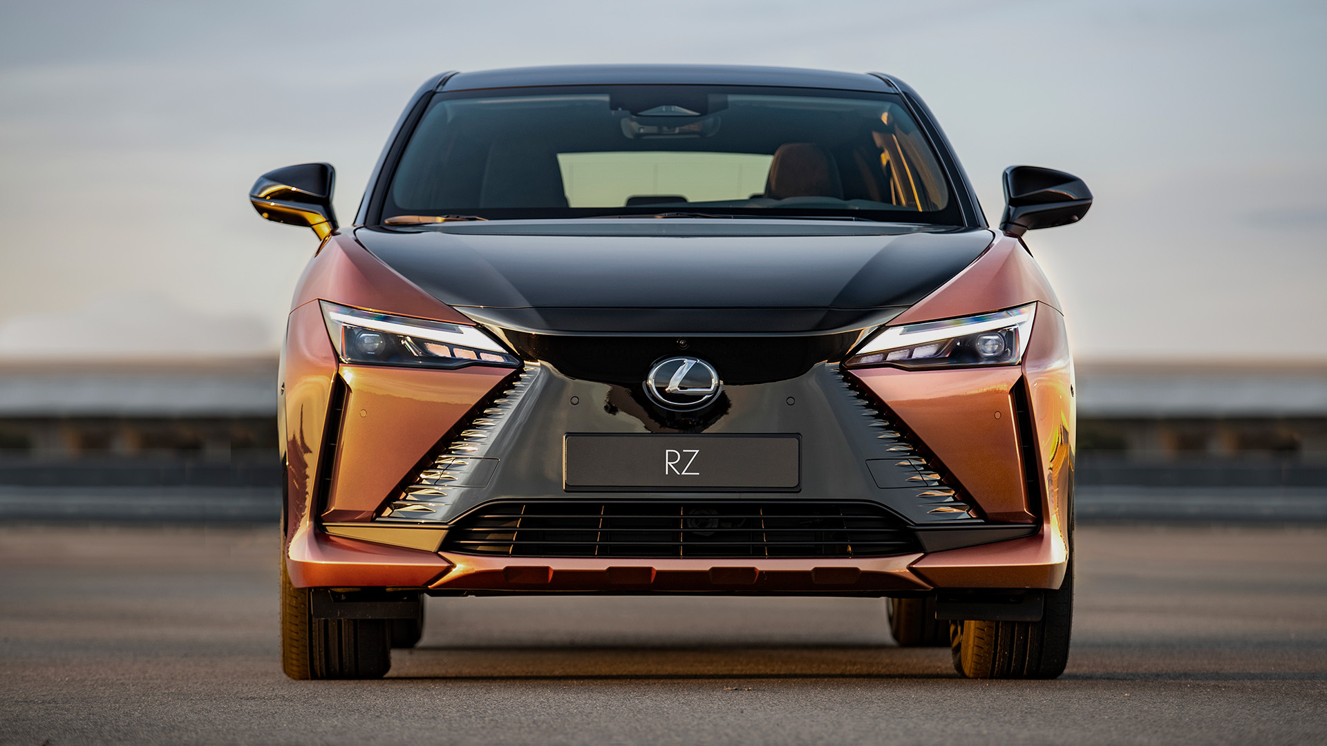 The front of an orange Lexus RZ 450e