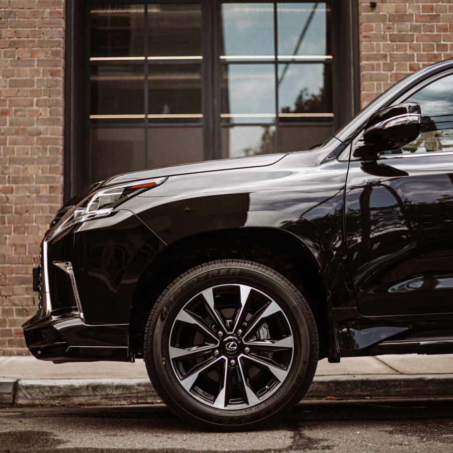 2021 Lexus LX 570 S exterior parked on a damp street. Showcasing alloy wheels.