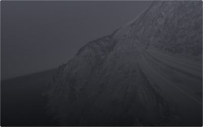 A Lexus driving along a mountain landscape with a winding path.